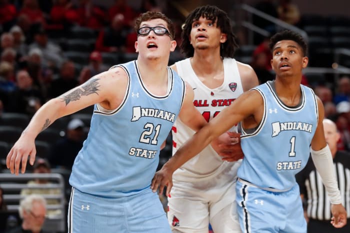 Indiana State Sycamores center Robbie Avila (21) and guard Julian Larry (1) box out Ball State Cardinals forward Basheer Jihad (11) during a men’s basketball game on Dec. 16, 2023, at Gainbridge Fieldhouse in Indianapolis. Indiana State Sycamores won 83-72.